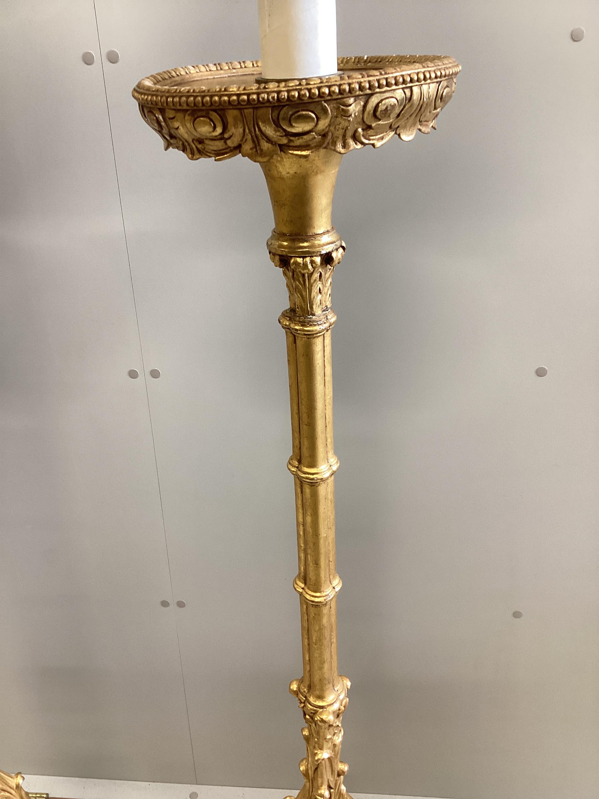 A pair of 18th century style carved gilt cluster column tripod standard lamps, height including shades 188cm